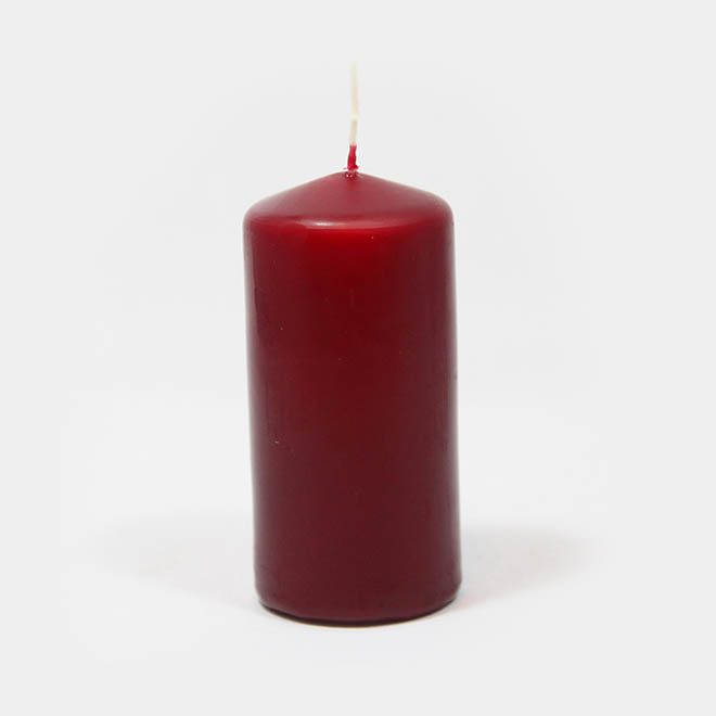 eine weinrote Stumpen-Kerze